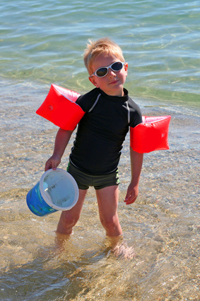 Petit garçon en combinaison anti-UV plage